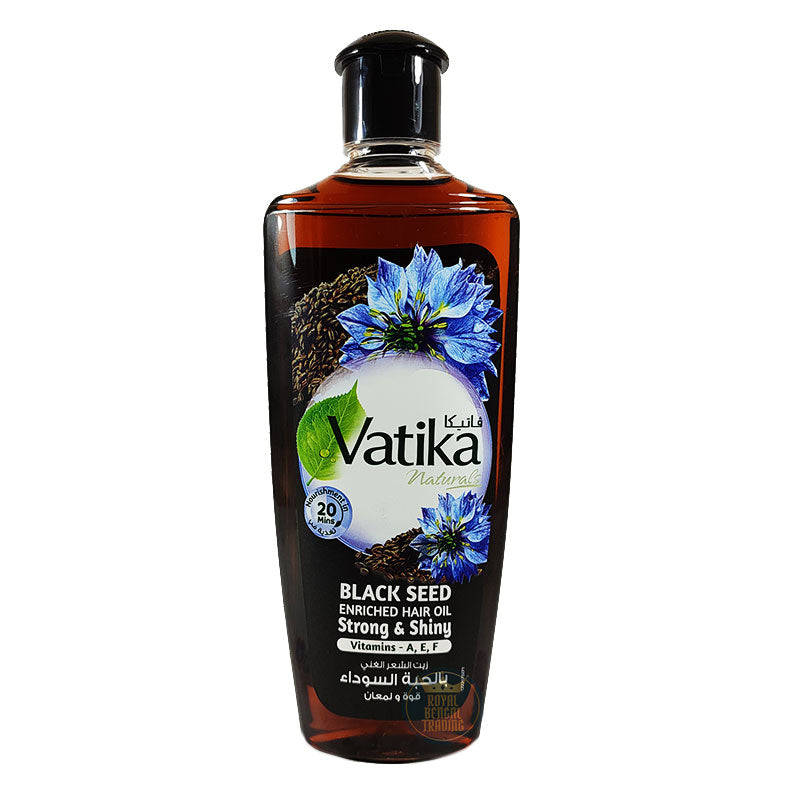 A bottle of Vatika Naturals Black Seed Enriched Hair Oil, Strong & Shiny, featuring a black cap and a label with blue flowers and black seed illustrations, set against a plain white background.