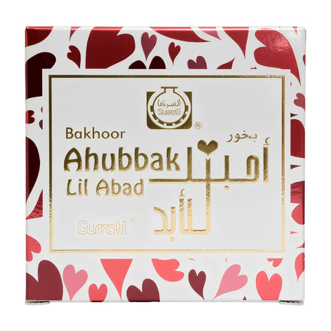 A square white box of Surrati Bakhoor Ahubbak Lil Abad perfume, decorated with a red and pink heart pattern on the borders and a gold foil label in the center.Ahubbak lil Abad Choco Bakhoor 40g – Surrati