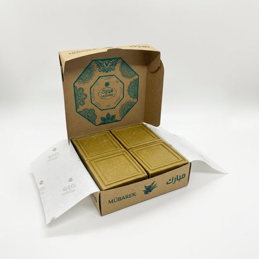 Gold chocolate bars in a branded box on a white background