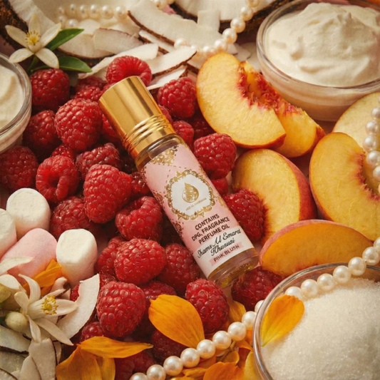 Perfume bottle surrounded by raspberries, peaches, and pearls oShams Al Emarat Khususi Pink Blush Perfume Oil 10ml – Ard Al Zaafarann a decorative background