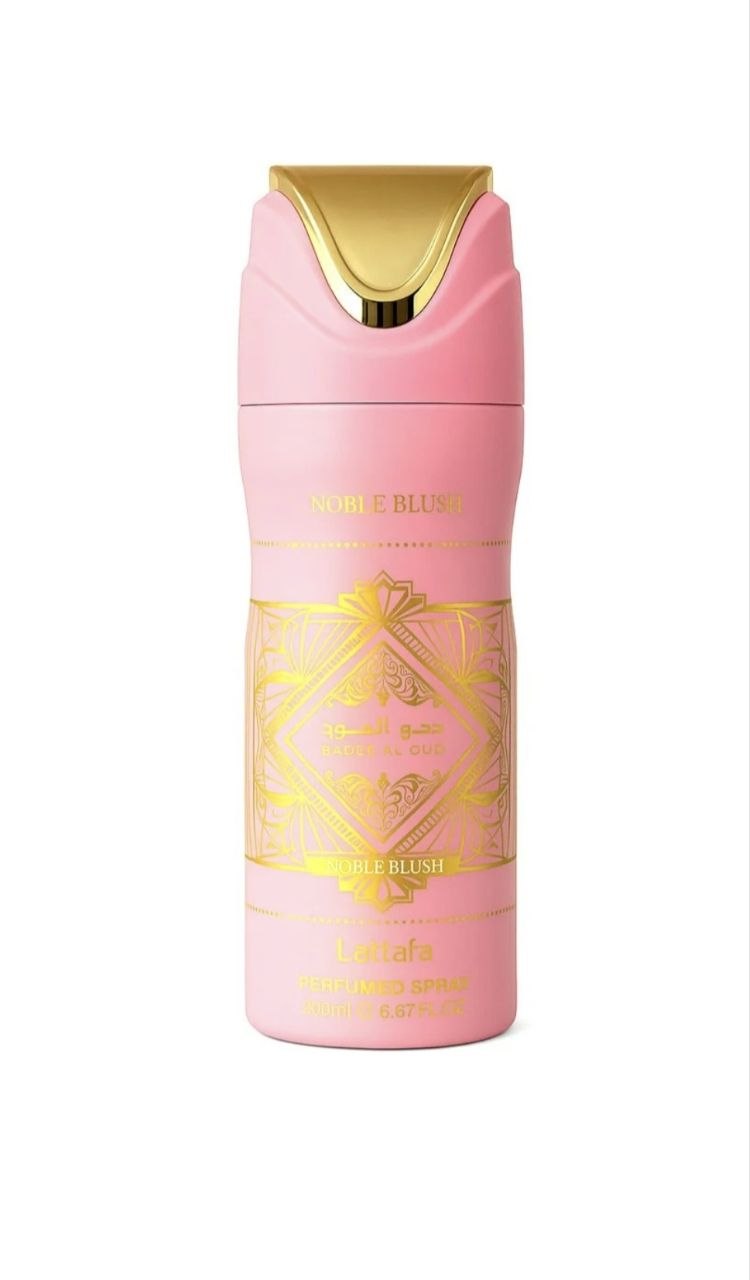 A pink cosmetic spray bottle with a gold cap and gold decorative label details, shown on a plain white background.