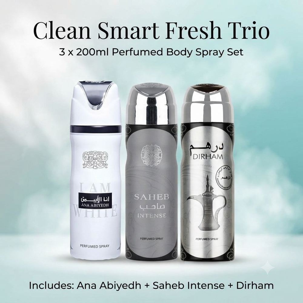 Three perfume body spray cans shown together under the heading 'Clean Smart Fresh Trio' with text noting a 3 x 200ml perfumed body spray set. The products are branded Ana Abiyedh, Saheb Intense, and Dirham, with white, silver-gray, and silver metallic color schemes on a soft light blue/white background.