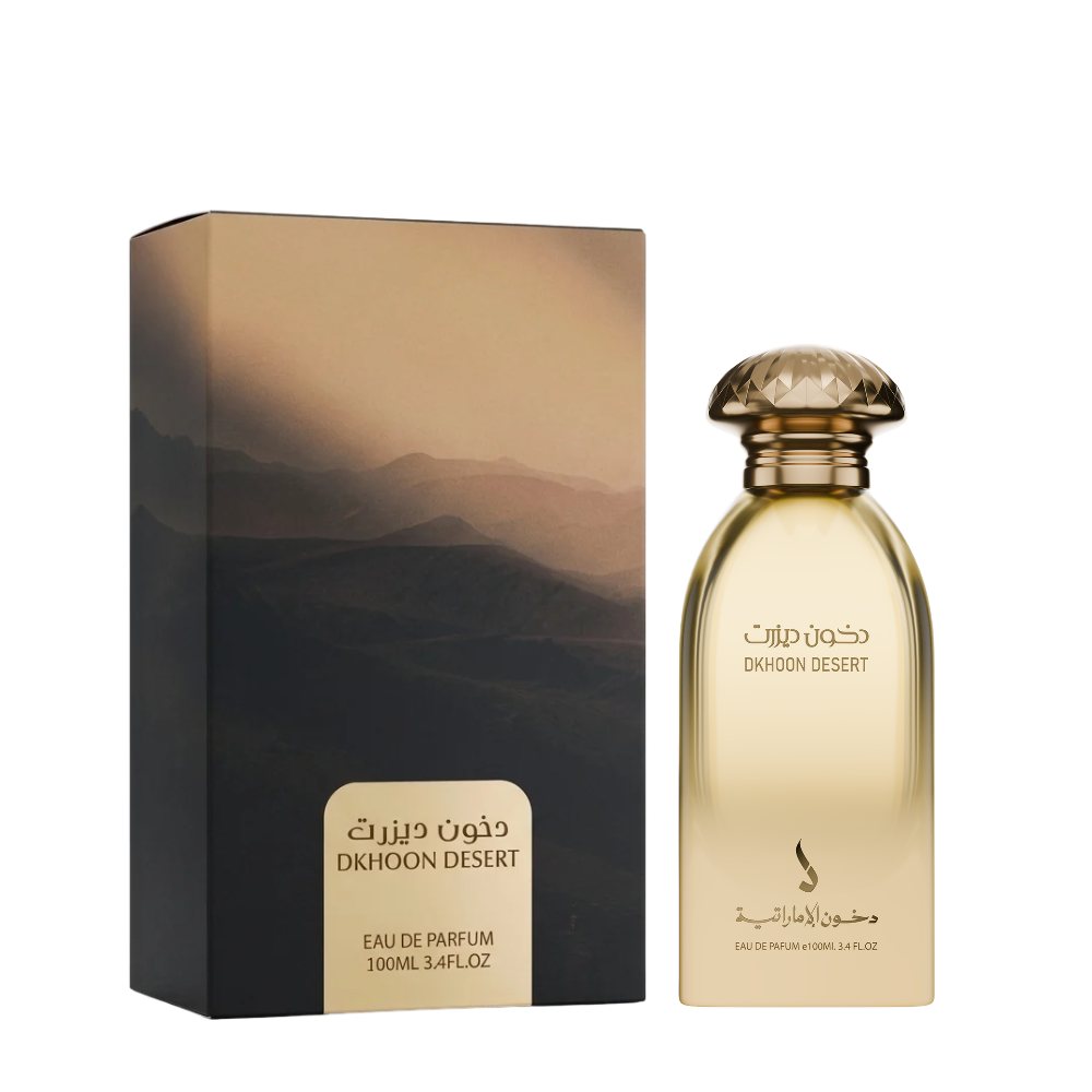 A bottle of DKHOON DESERT Eau de Parfum next to its packaging box, both featuring a desert mountain landscape design in shades of gold, brown, and black, on a solid white background.
