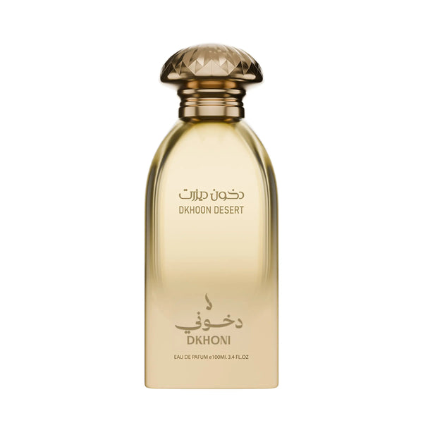 A bottle of Dkhoon Desert Eau de Parfum with a faceted gold cap and a translucent golden-amber bottle, featuring Arabic and English text on a plain white background.