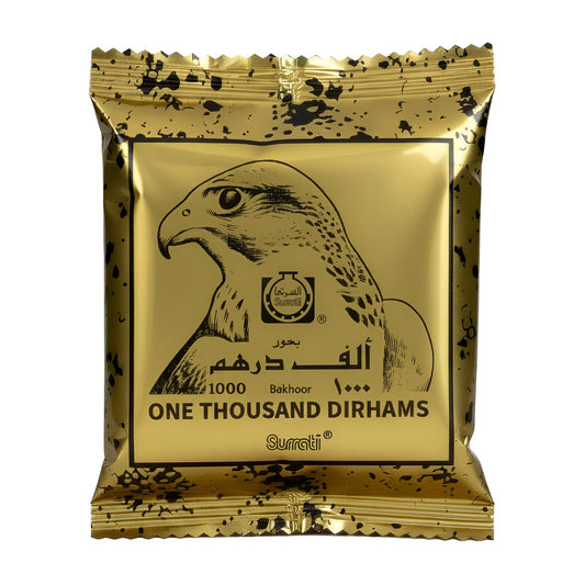 Gold packaging of Surrati Bakhoor with a falcon illustration and text. Bukhoor One Thousand 40g – Surrati