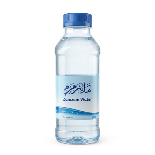 A clear plastic bottle of Zamzam Water with a blue screw cap and a white label featuring blue text and wave graphics, isolated on a white background.Original Zamzam Water 500ml – Makkah, Saudi Arabia