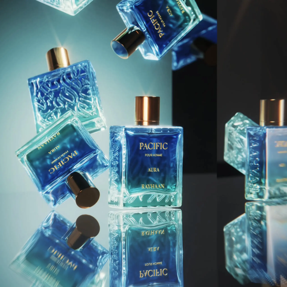 Blue perfume bottles with gold caps on a reflective surface