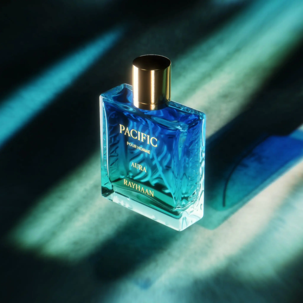 Blue perfume bottle labeled 'Pacifica' on a dark background