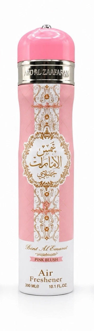 A pink cylindrical air freshener bottle with ornate gold and white decorative patterns, featuring the brand name 'MORAL ZAFARAN' and the scent 'Pink Blush'.Shams Al Emarat Khususi Pink Blush 300ml Air Freshener – Ard Al Zaafaran