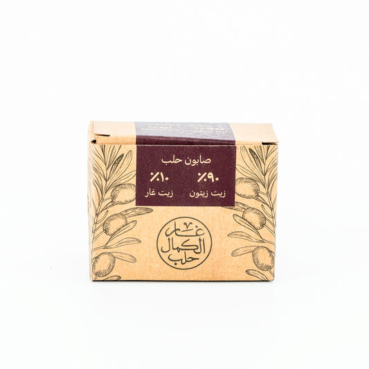Soap bar with a brown packaging featuring olive tree design and Arabic text on a white background