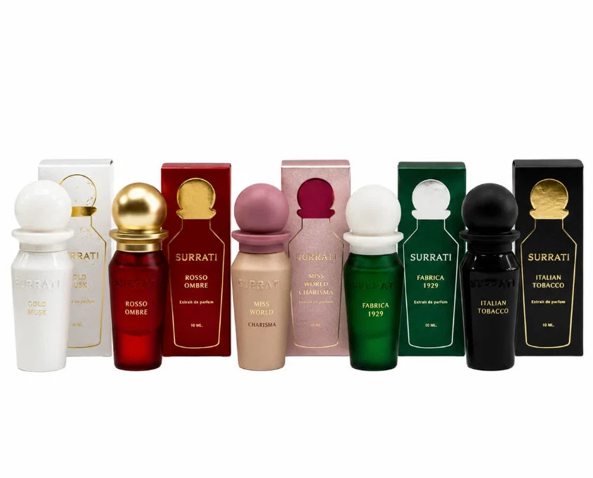 A lineup of ten Surrati cologne bottles and their matching retail boxes, showcasing different scent profiles in white, red, beige, pink, green, and black, set against a plain white background.Surrati Mini Collection 1- 5 x 10ml EDP Spray Gift Set