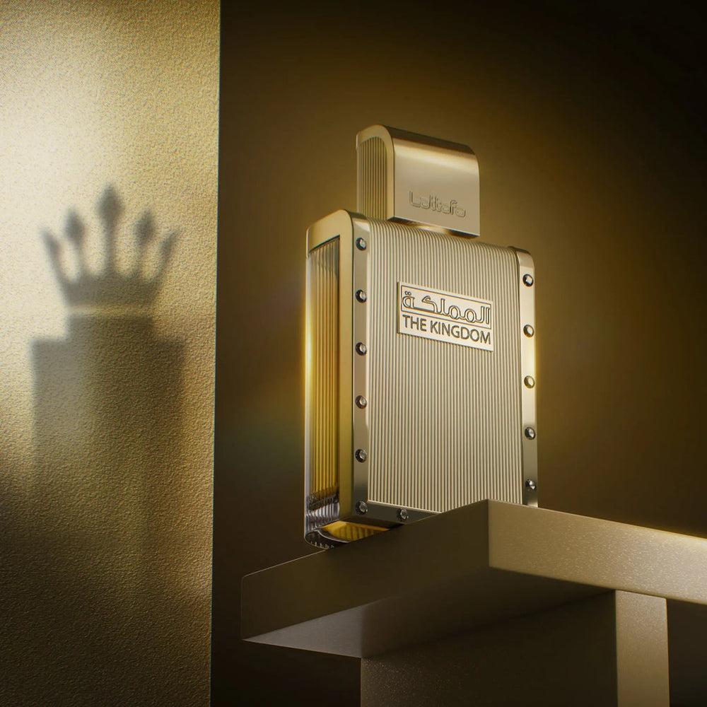 Gold perfume bottle with 'The Kingdom' branding on a textured gold background