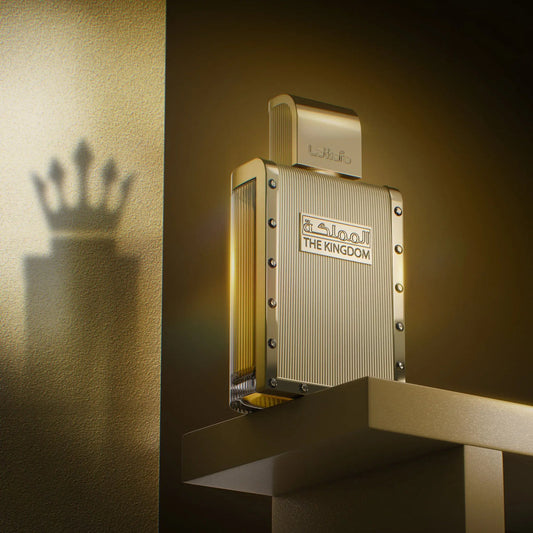 Gold perfume bottle with 'The Kingdom' branding on a textured gold background