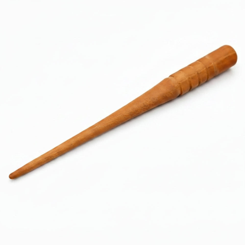 A smooth light brown wooden hairpin with tapered point and textured grip for traditional arabian kohl with zamzam water and rose water