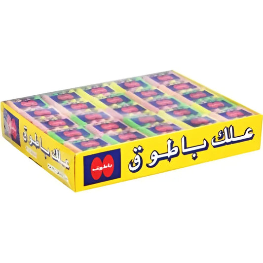 Yellow cardboard batook chewing gum display box with assorted flavours and colorful candy wrappers featuring arabic text