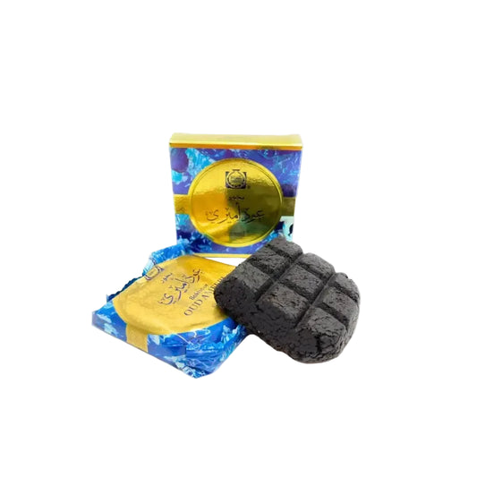 Black rectangular block of charcoal with grid pattern surface of bukhoor oud ameeri 40g by Surrati