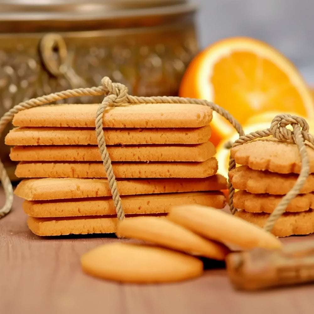 Stacks of golden-brown orange biscuits tied with natural twine from el saidy egyptian cookies 420g package