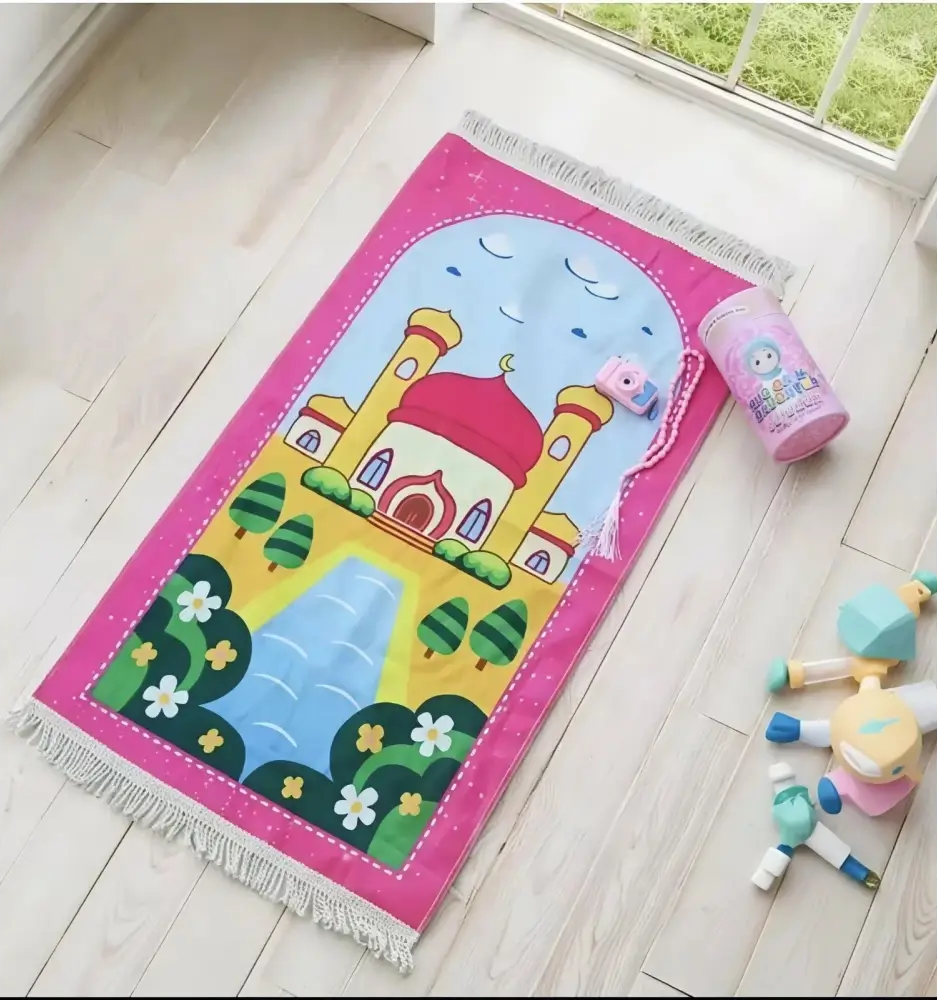 Pink small prayer mat for kids with cartoon mosque design featuring yellow minarets and red dome in prayer rug set