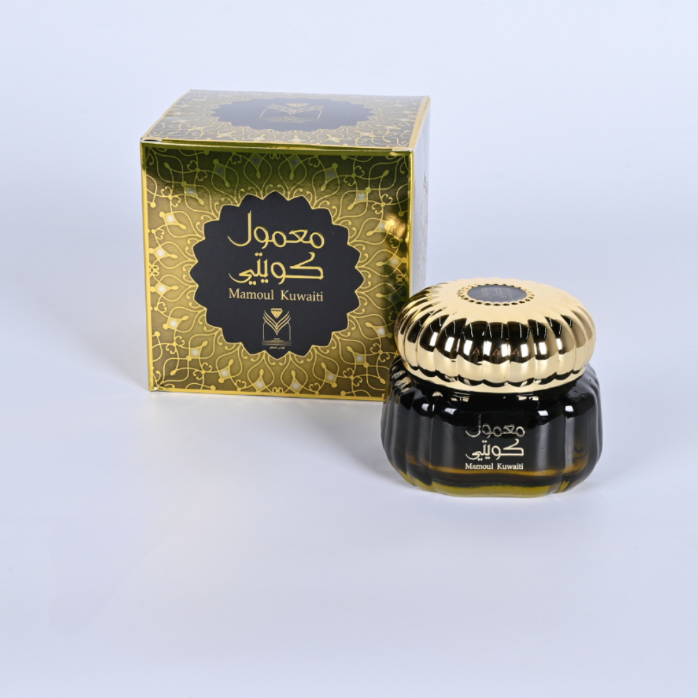 Perfume bottle with gold cap and decorative box on a light gray background