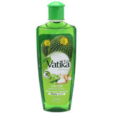 A bottle of Vatika Cactus Enriched Hair Oil with a green cap and a green label featuring cactus and garlic illustrations, set against a plain white background.