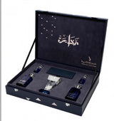An open dark blue presentation box containing a set of perfume bottles and a rectangular box, photographed on a plain white background. The inside lid has Arabic calligraphy and branding text.Al Fakhama Luxury Fragrance Gift Set 6 Pieces – Dkhoon AlEmiratia