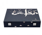 A dark navy blue rectangular presentation box with silver-tone metal latches, featuring white Arabic calligraphy and small geometric triangle accents on the lid, photographed on a plain white background.Al Fakhama Luxury Fragrance Gift Set 6 Pieces – Dkhoon AlEmiratia