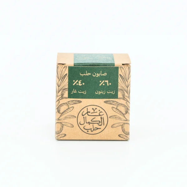 Bar of soap in a cardboard box with green label on a white background