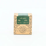 Bar of soap in a cardboard box with green label on a white background