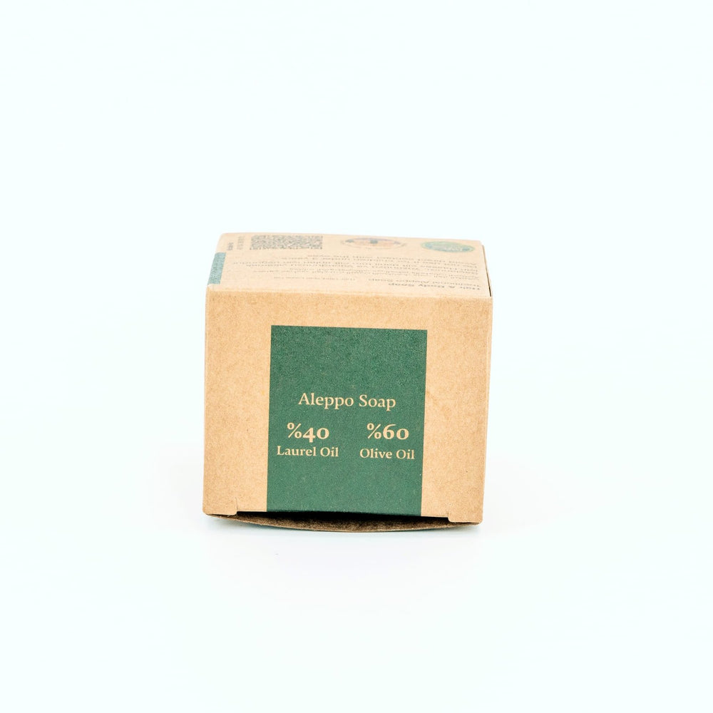 Bar of Aleppo Soap with cardboard packaging on a white background