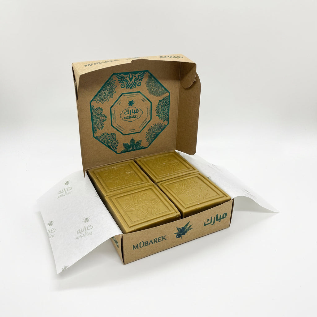 Gold chocolate bars in a branded box on a white background