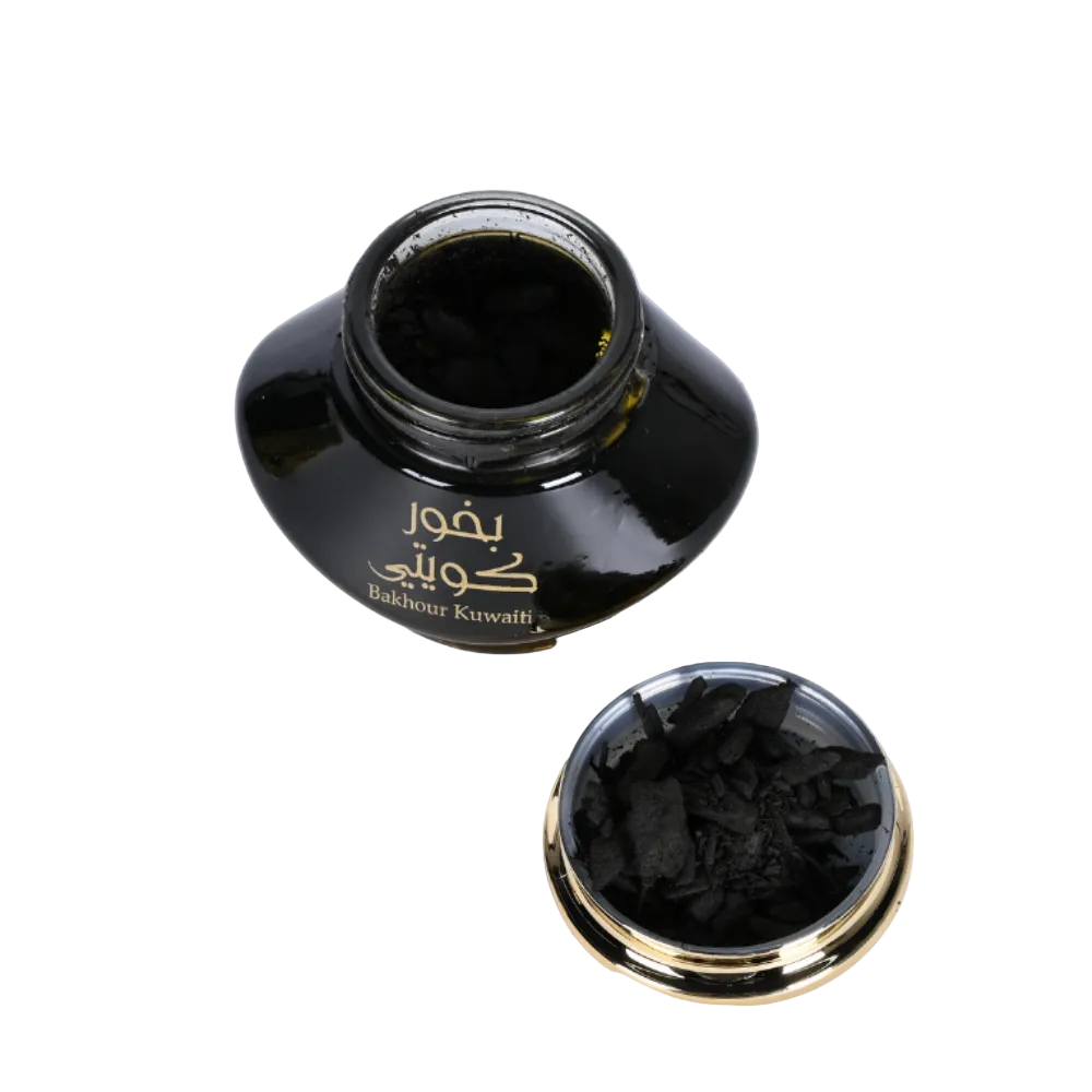 Black ink bottle with gold cap on a white background