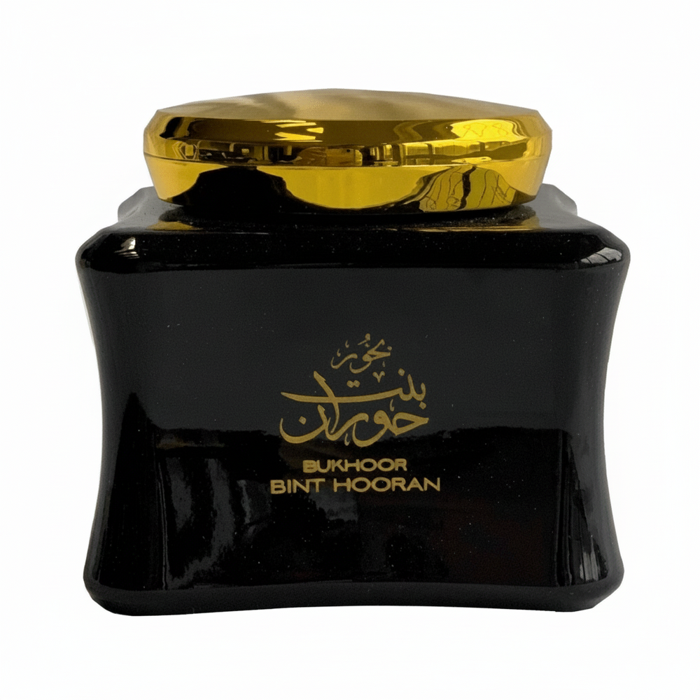 Black container with gold lid and text on a white background