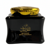 Black container with gold lid and text on a white background
