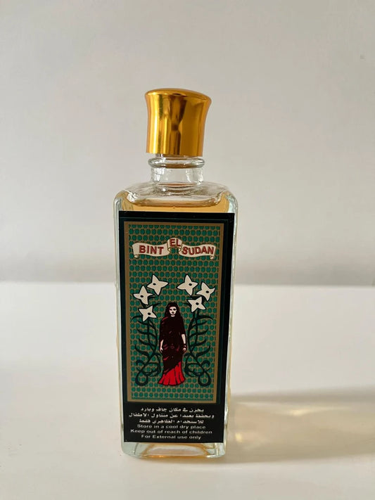 A rectangular glass bottle of El Bint El Sudan perfume with a shiny gold cap and a detailed black label featuring a gothic figure and stars, set against a p Bint El Sudan – Chypre EDT 100mllain light background.