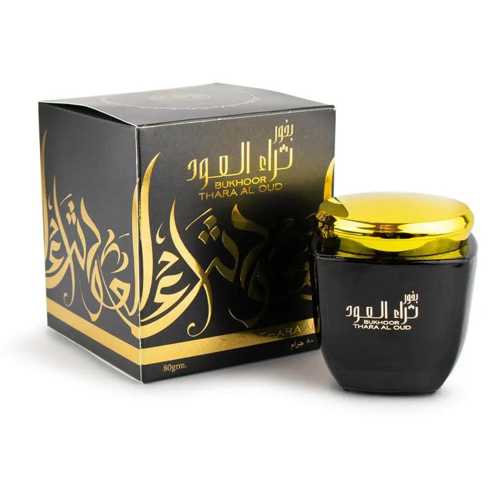 Black and gold perfume bottle with packaging on a white background