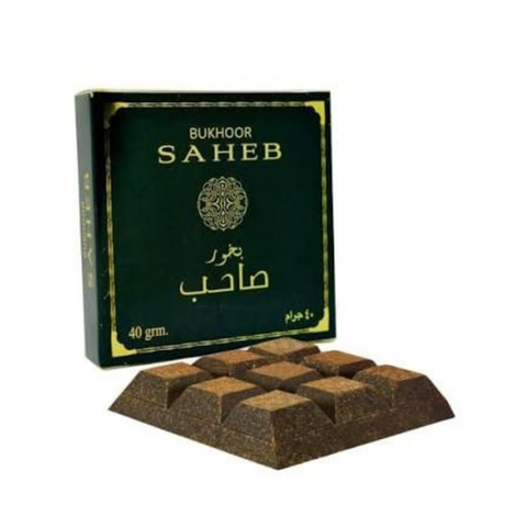 A box of Bukhoor Saheb incense sticks with several brown incense blocks displayed in front on a plain white background.Bukhoor Saheb 40g – Ard Al Zaafaran