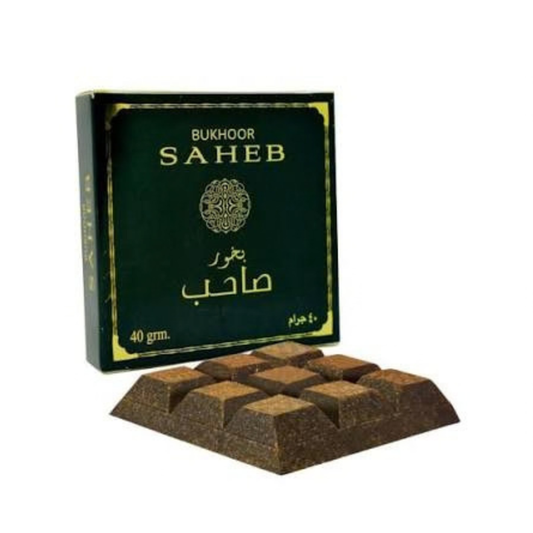A box of Bukhoor Saheb incense sticks with several brown incense blocks displayed in front on a plain white background.Bukhoor Saheb 40g – Ard Al Zaafaran
