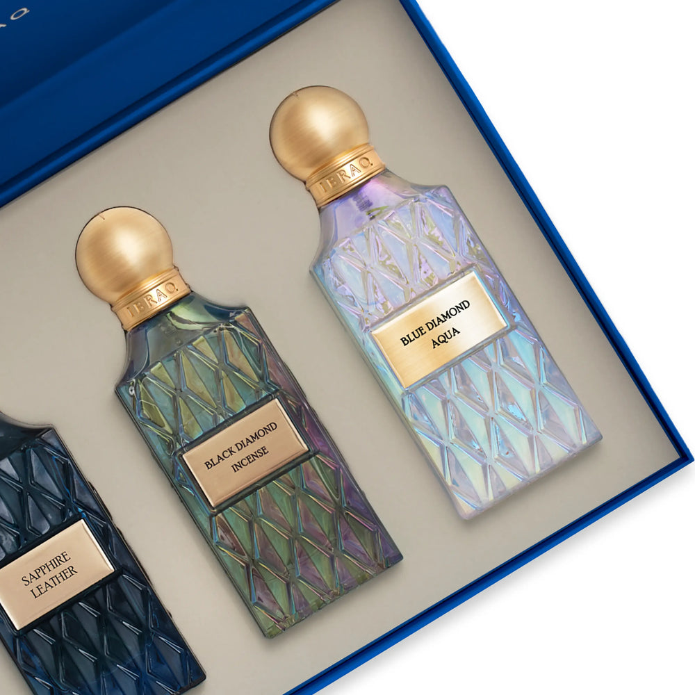 Two perfume bottles with gold caps and labels in a box