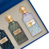 Two perfume bottles with gold caps and labels in a box