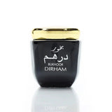 Black container with gold lid labeled 'Bukhoor Dirham' on a white background