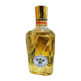 A faceted glass bottle of Chinese baijiu liquor with a shiny gold cap and a round white label reading 'Premium & Deposit'. The bottle is filled with golden liquid and is photographed against a plain white background.