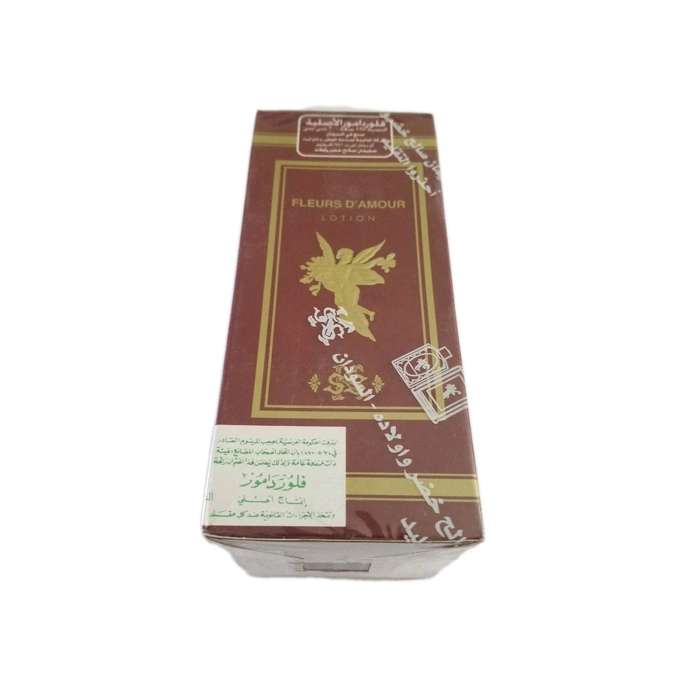 A rectangular box of Fleurs D'Amour Lotion, featuring a dark reddish-brown color with gold borders, a gold winged emblem, and a white label at the bottom, set against a plain white background.