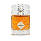 A bottle of Golden Elixir perfume by Ruffs, featuring an amber-colored liquid inside a clear, diamond-patterned glass bottle with a matching textured cap.Golden Elixir Extrait de Parfum 100ml – Riiffs