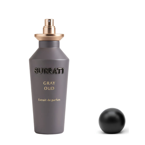 Gray Surrati perfume bottle with gold cap on a white background