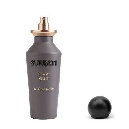 Gray Surrati perfume bottle with gold cap on a white background