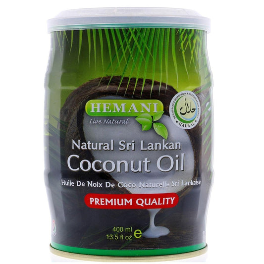 A 400 ml plastic canister of Hemani Natural Sri Lankan Coconut Oil on a white background. The label features green palm leaves, a sliced coconut, and a red banner indicating 'PREMIUM QUALITY'.Hemani Pure Sri Lankan Coconut Oil 400ml