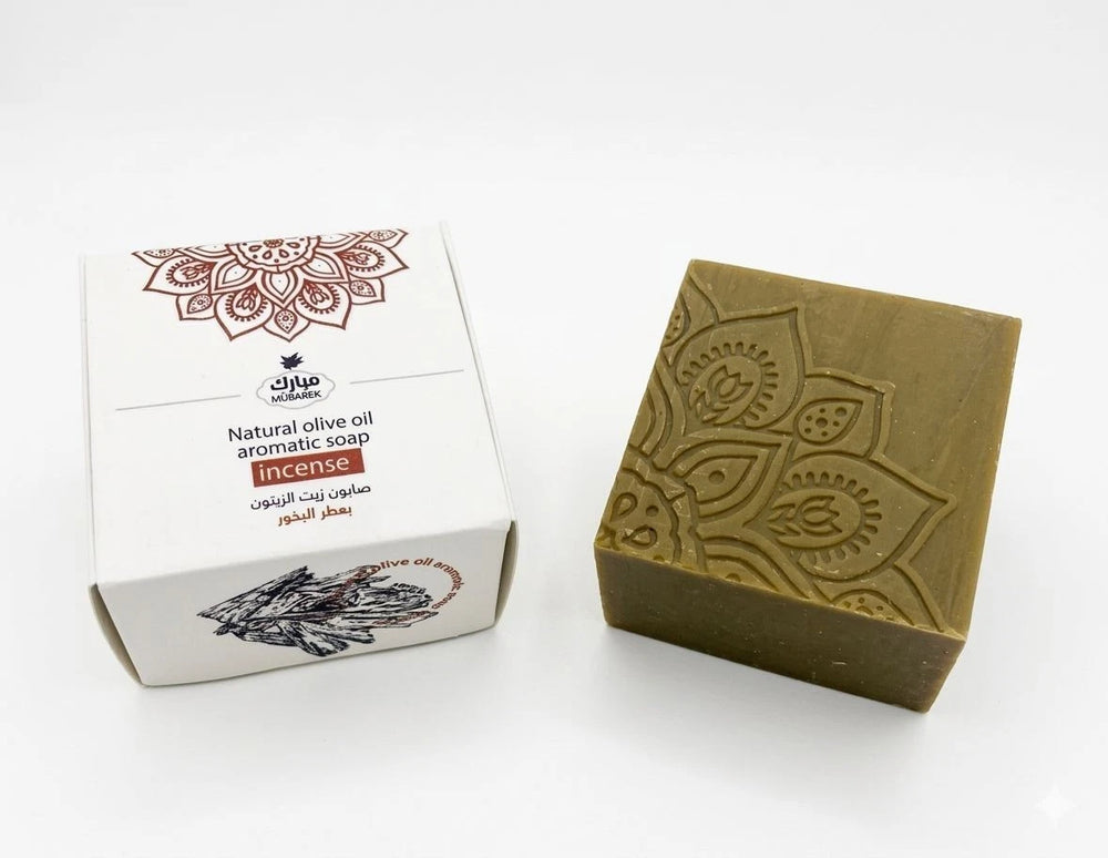 Olive oil aromatic soap with decorative packaging on a white background