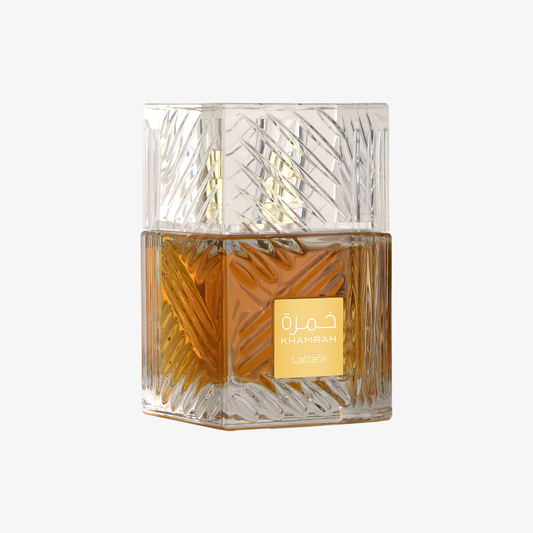 Glass perfume bottle with geometric design on a white background