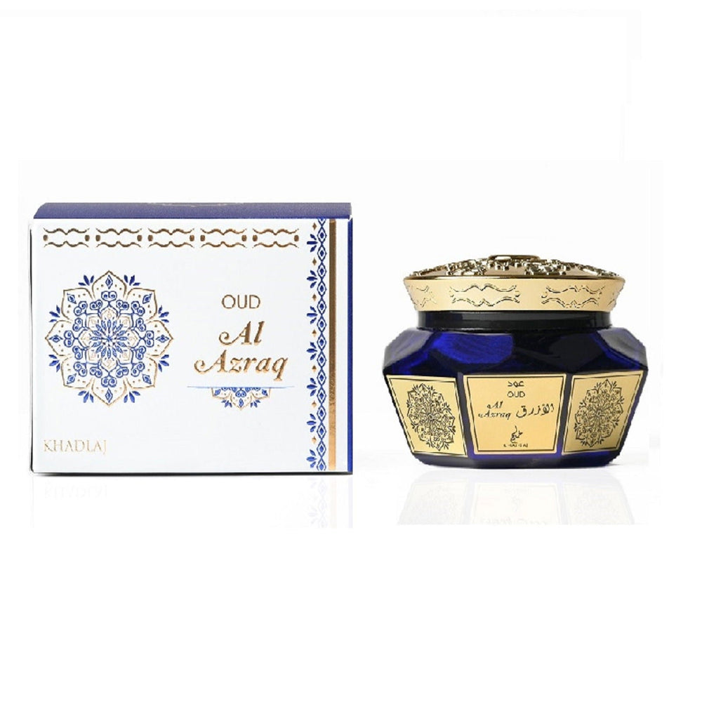 Blue and gold container with decorative design next to its packaging on a white background Al Azraq Oud Muattar Bakhoor 40g – Khadlaj