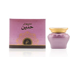 Perfume bottle with pink packaging on a white background Maamul Haneen Oud Muattar Bakhoor 48g – Khadlaj